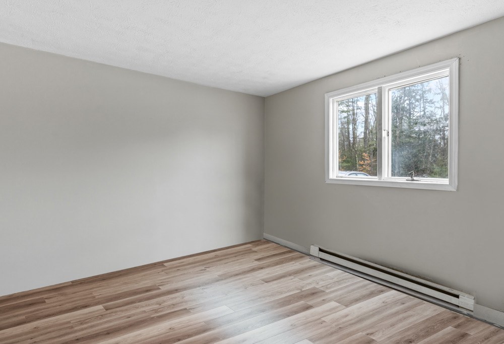 Bedroom with new flooring in a Hollis apartment